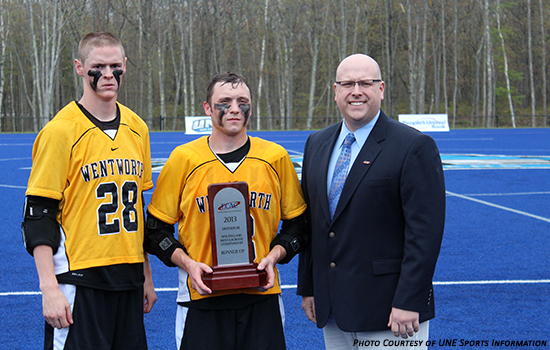 Co-captains Tyler Forthofer and Chris Kipp accept the ECAC runner-up trophy from ECAC liaison Dave Morin
